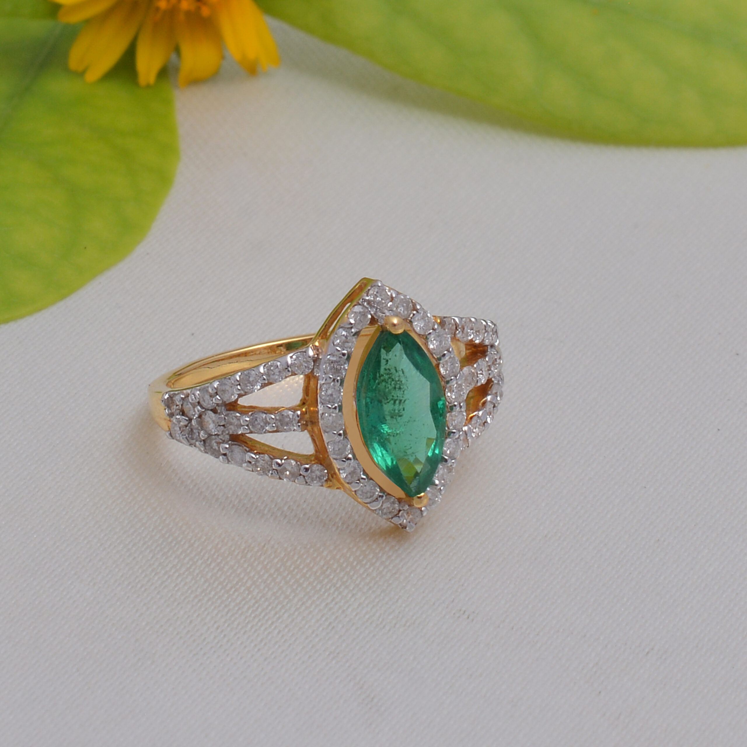 Marquise shaped emerald & diamond ring in 18KT yellow gold